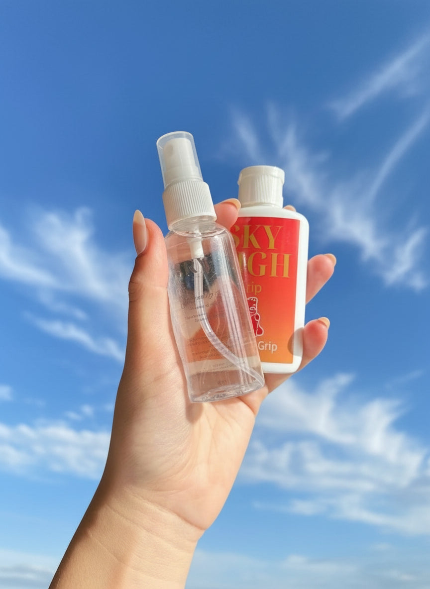 Hand holding a clear spray bottle and a red and white bottle labeled 'Sky High Grip'