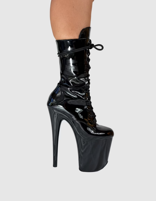 Black patent leather platform boot on a white background